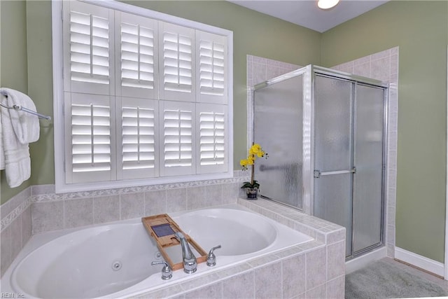 bathroom with a jetted tub and a shower stall