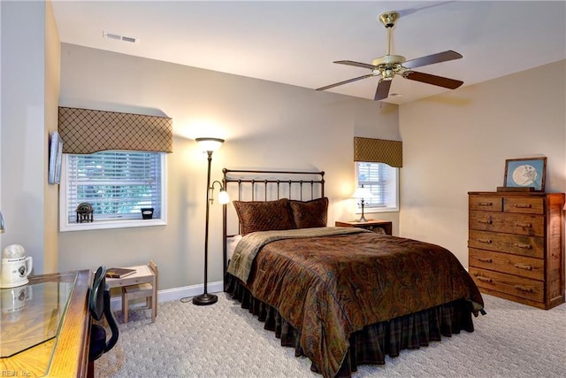 bedroom with a ceiling fan, baseboards, visible vents, and carpet flooring