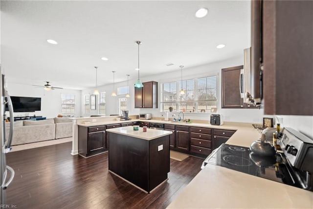 kitchen featuring electric stove, open floor plan, dark wood-type flooring, and dark brown cabinetry