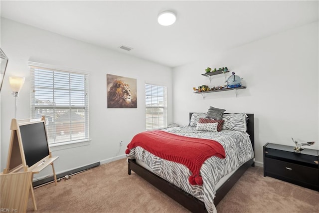 carpeted bedroom featuring visible vents and baseboards