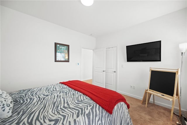 carpeted bedroom featuring baseboards