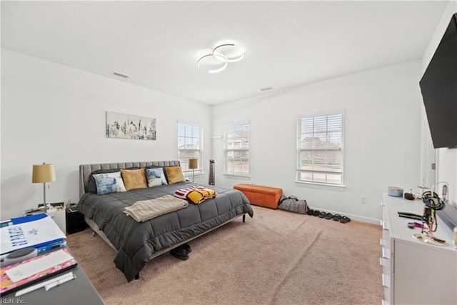 bedroom with carpet floors, visible vents, and baseboards