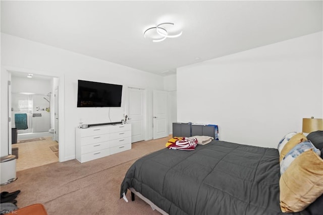 bedroom with connected bathroom and light colored carpet