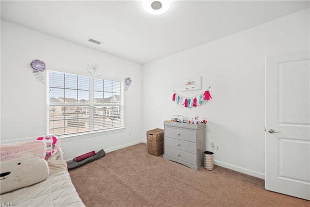 carpeted bedroom with visible vents and baseboards