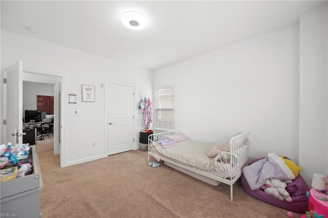 bedroom featuring light colored carpet and baseboards