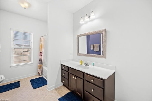 bathroom with toilet, shower / bath combination with curtain, vanity, and baseboards