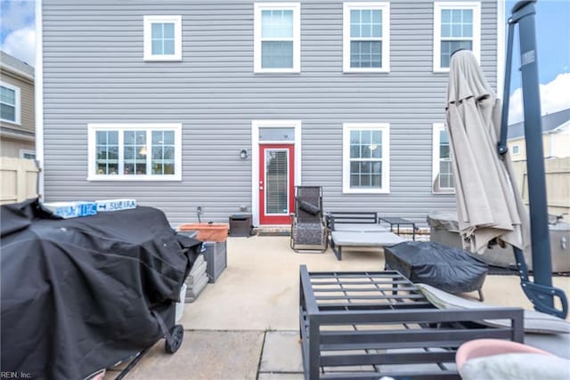 back of property featuring a patio and fence