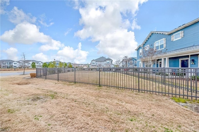 view of yard featuring fence and a residential view