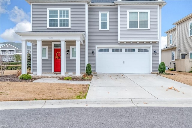 view of front of house with concrete driveway, a porch, and an attached garage