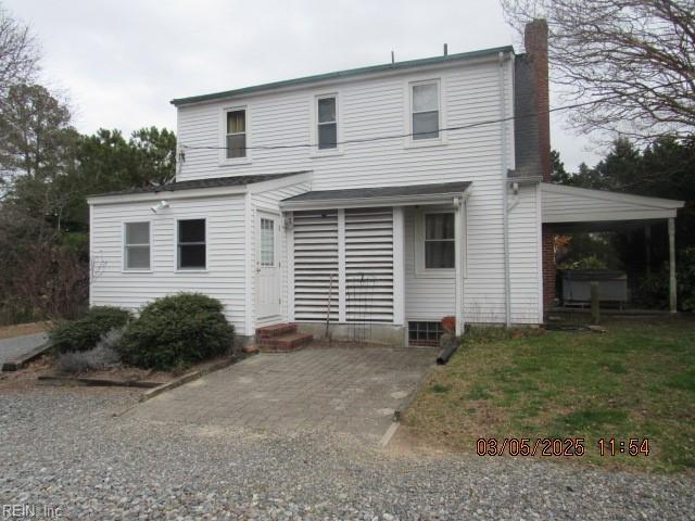 view of front facade with entry steps and a chimney