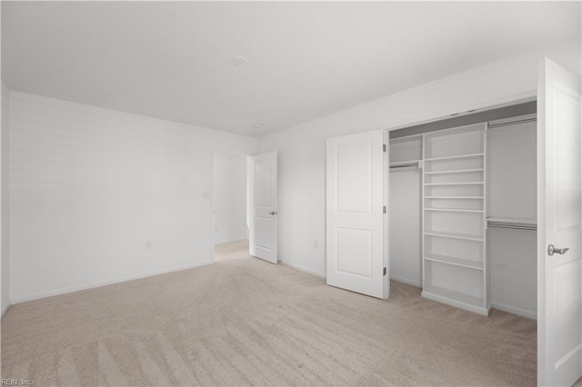 unfurnished bedroom featuring a closet, carpet flooring, and baseboards