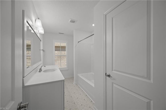 bathroom with shower / washtub combination, vanity, visible vents, and tile patterned floors