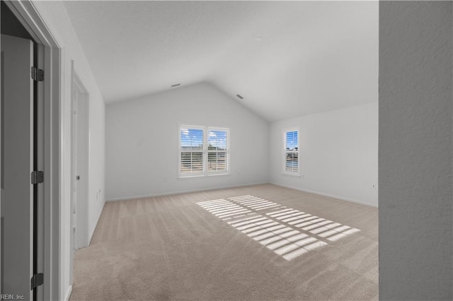 interior space featuring vaulted ceiling and baseboards