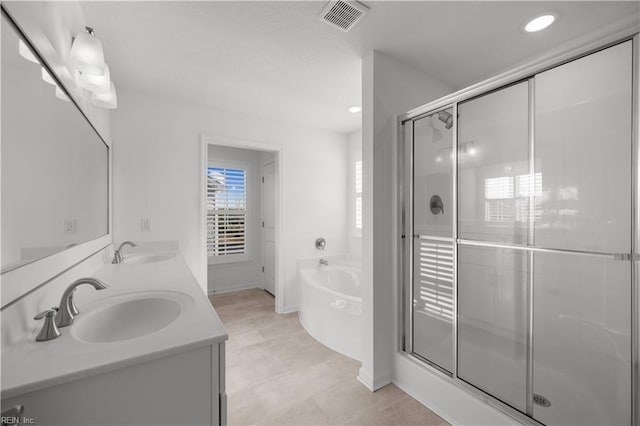 bathroom featuring a garden tub, a sink, visible vents, and a shower stall