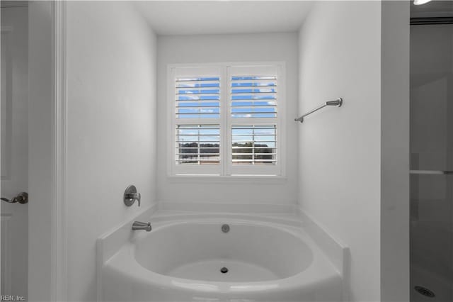 full bathroom featuring a shower and a garden tub