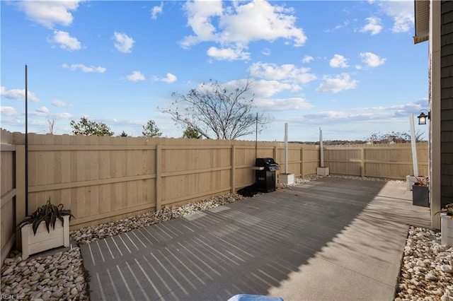 wooden deck featuring a fenced backyard