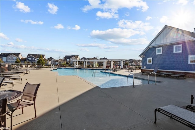 community pool featuring a residential view, a patio area, and a pergola