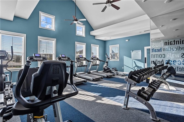 workout area featuring high vaulted ceiling, a ceiling fan, and baseboards