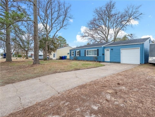 ranch-style house featuring driveway, a front lawn, and an attached garage