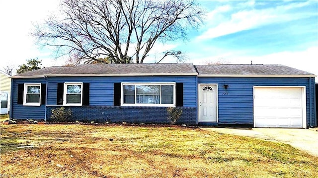 ranch-style home with a garage, driveway, brick siding, and a front lawn