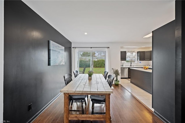 dining area featuring baseboards and wood finished floors