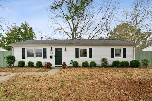 ranch-style home with fence