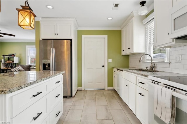 kitchen with backsplash, ornamental molding, a ceiling fan, a sink, and white appliances