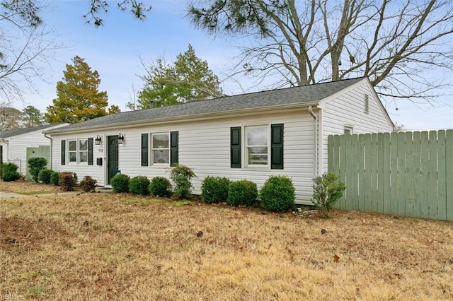 ranch-style home featuring fence