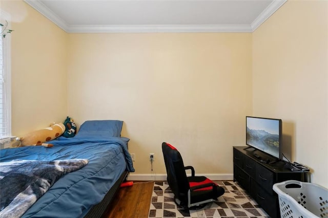 bedroom with ornamental molding, wood finished floors, and baseboards