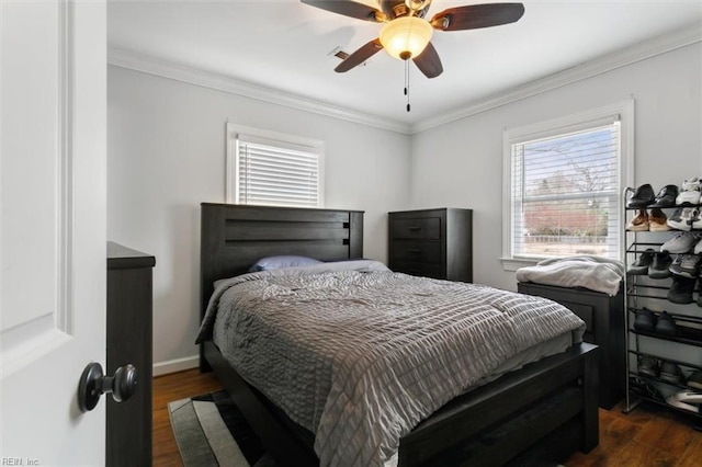 bedroom featuring dark wood-style floors, baseboards, a ceiling fan, and crown molding