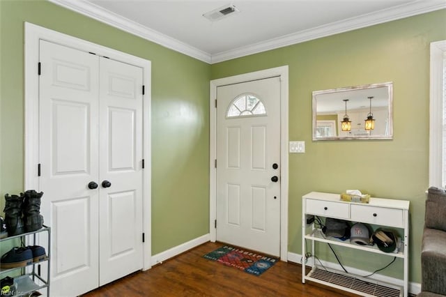 entrance foyer featuring baseboards, crown molding, visible vents, and dark wood-type flooring