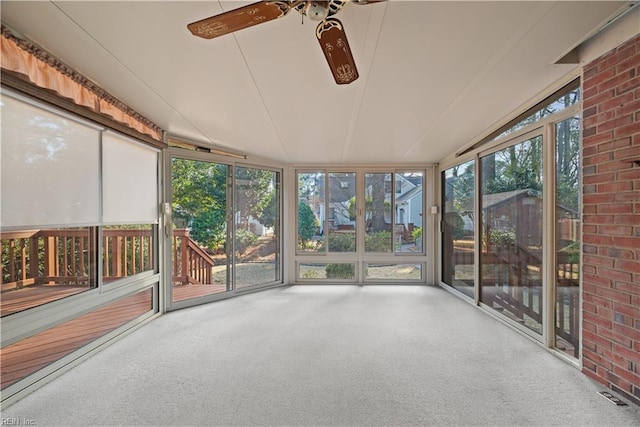 unfurnished sunroom featuring visible vents and a ceiling fan