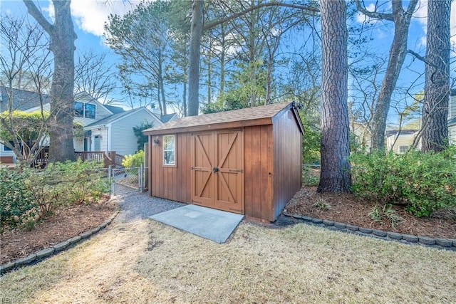 view of shed with fence