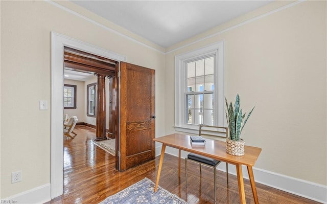 office space featuring crown molding, baseboards, and hardwood / wood-style floors