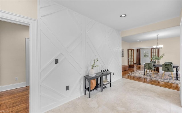 interior space with baseboards, a chandelier, and recessed lighting