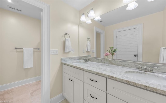 full bathroom with double vanity, a sink, visible vents, and baseboards