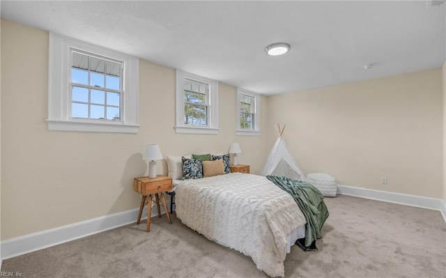 carpeted bedroom with baseboards