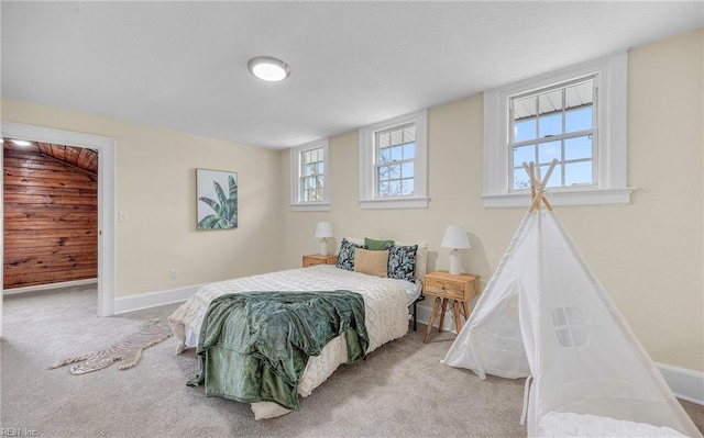 bedroom featuring carpet floors and baseboards