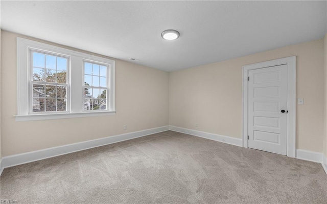 empty room with carpet flooring and baseboards