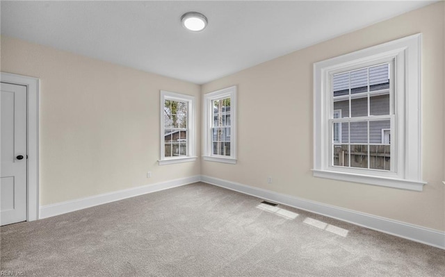 carpeted spare room with baseboards