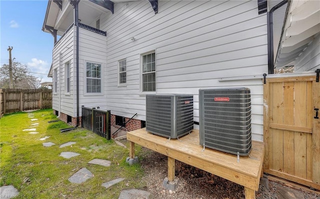 exterior space featuring fence and central AC unit