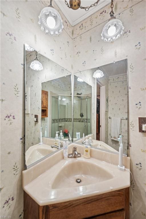 bathroom with wallpapered walls, vanity, and a stall shower