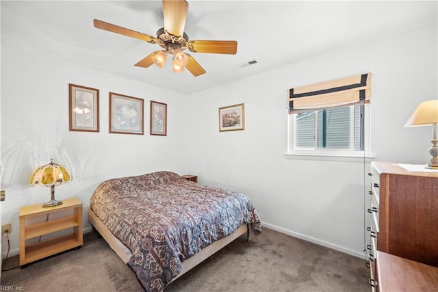 carpeted bedroom featuring a ceiling fan, visible vents, and baseboards