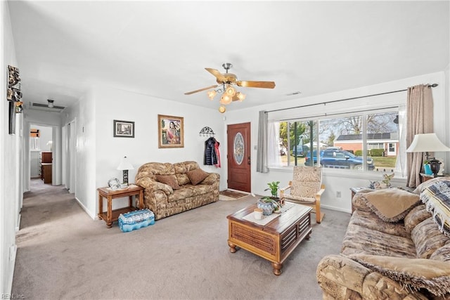 living area featuring a ceiling fan, carpet flooring, and baseboards