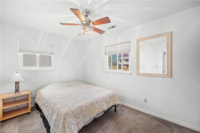 bedroom featuring a ceiling fan, baseboards, visible vents, and carpet flooring