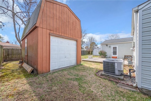 detached garage with fence and central air condition unit