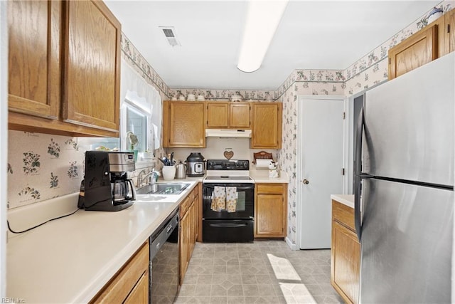 kitchen featuring range with electric stovetop, a sink, freestanding refrigerator, dishwasher, and wallpapered walls