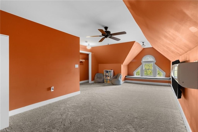 additional living space with a ceiling fan, carpet flooring, vaulted ceiling, and baseboards