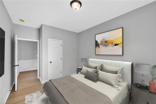 bedroom with wood finished floors and baseboards