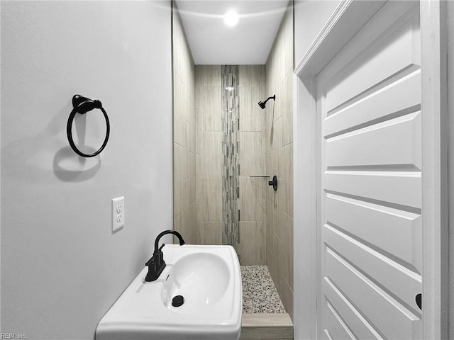 full bathroom with a stall shower and a sink